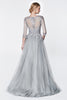 Magical flowy layered A-line tulle gown with three quarter sleeve and lace bodice.